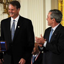 eBay Representative stands beside President George W. Bush