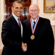Norman McCombs shakes hands with President Barack Obama