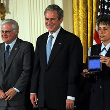 Representative from Skunk Works stands beside President George W. Bush