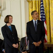 Esther Sans Takeuchi stands beside President Barack Obama